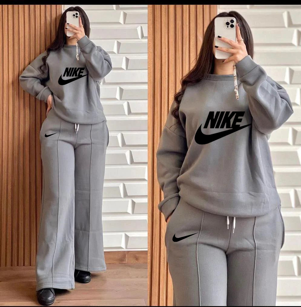 Printed Nike 2-piece winter outfit: gray sweatshirt and wide-leg pants set.