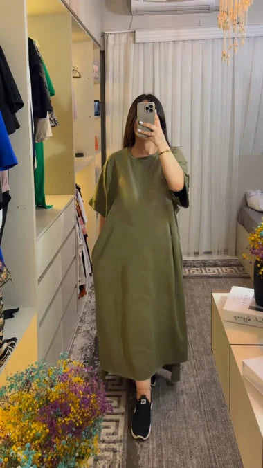 Loose green tunic top with short sleeves and round neckline